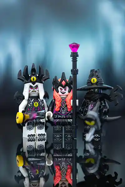 LEGO villains from the original LEGO DREAMZzz theme stand together in eerie unity. Each wears dark, ornate armor with eye motifs, glowing purple weapons, and ominous expressions, reflecting the surreal and spooky dream-world aesthetic.