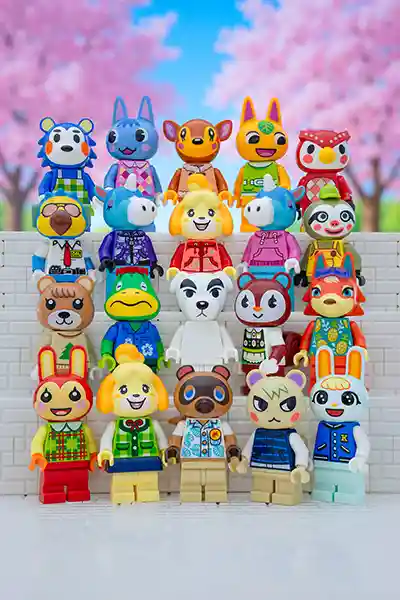 LEGO Animal Crossing minifigures arranged in rows against a vibrant backdrop of cherry blossom trees. Iconic characters like Isabelle, Tom Nook, K.K. Slider, and villagers like Marshal, Rosie, and Raymond are recreated in colorful LEGO form, showcasing their signature outfits and cheerful expressions.