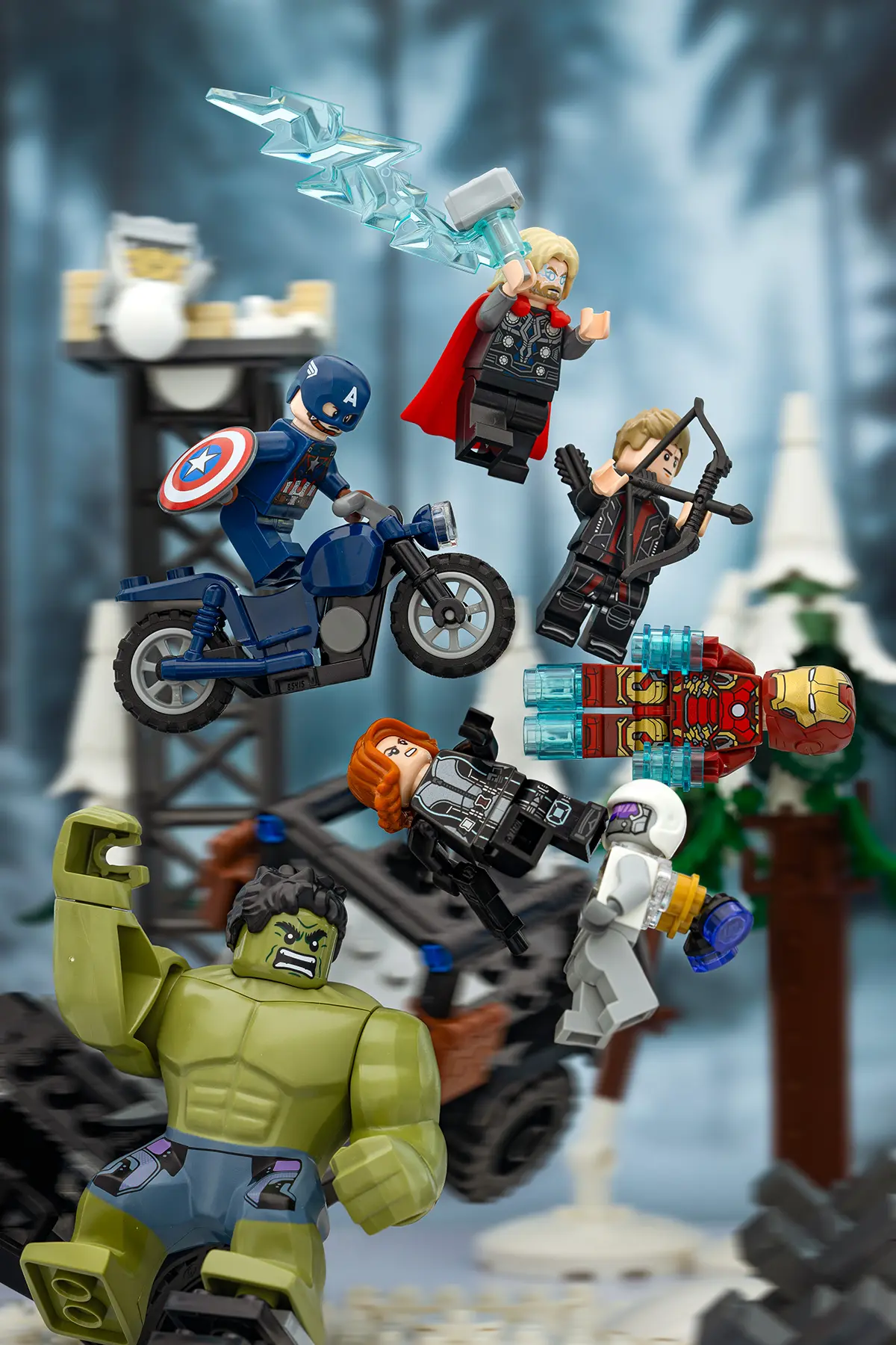 LEGO Avengers minifigures in a dynamic battle scene set in a snowy forest. All Support bars and transparent rods have been removed in post-editing, creating the illusion of characters flying and leaping freely through the air.