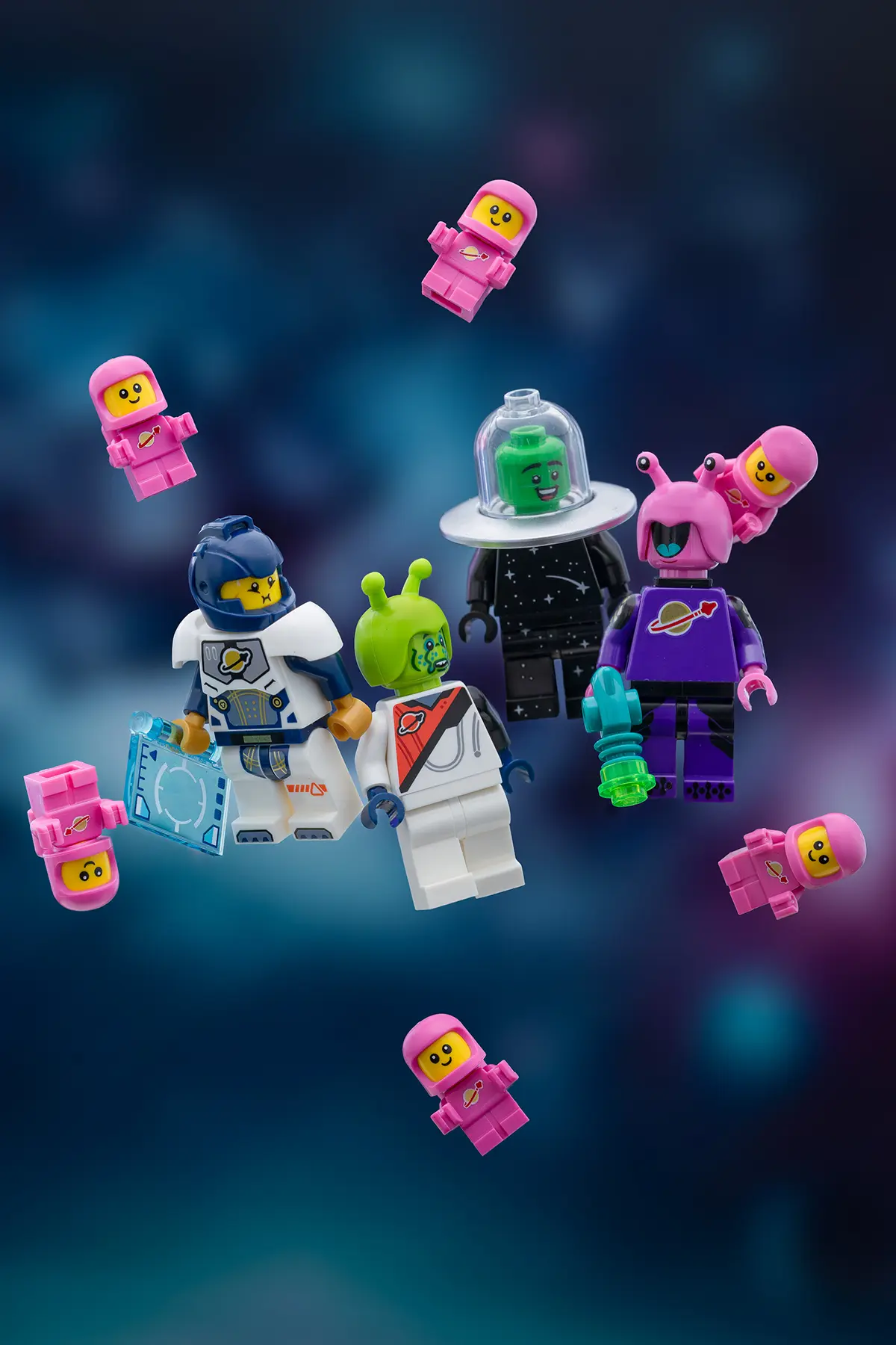 The same LEGO characters appear to float freely in a stylized outer space scene, with all support stands removed and improved lighting and composition giving a clean, zero-gravity effect.